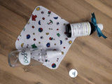 Odd Pod Reusable Baby Wipe in cotton flannel, featured with Apricot Kernel Oil and a Glass Spray Bottle that are often used with the wipe.