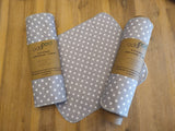 Odd Pod Kitchen Unpaper Towel in grey with white polko dots, featured in a pack of 8 and on a kraft roll. These reusable wipes are made from 100% cotton flannel.