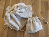 Odd Pod 100% cotton laundry mesh wash bags, featured in the medium size for larger items and reusable wipes, and our smaller laundry bag for our mini face wipes.