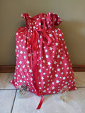 Odd Pod Large Christmas Gift Sack, made from 100% cotton in a lovely red and white stars design to suit Christmas. Sealed with a matching drawstring ribbon.