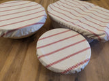 Dish cover set made from 100% cotton in white with red stripes. Available in sets of three.
