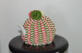  By the Tea Cosy Project - Hand knit tea cosy in a fusion of protea colours, with a pink accent and flowers on top with the same colour theme.